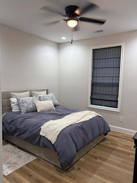 600 Lucas Drive, Athens, TX 75751 Room featuring wood-finish flooring, a window with roman shades, recessed lighting, and a ceiling fan with integrated light