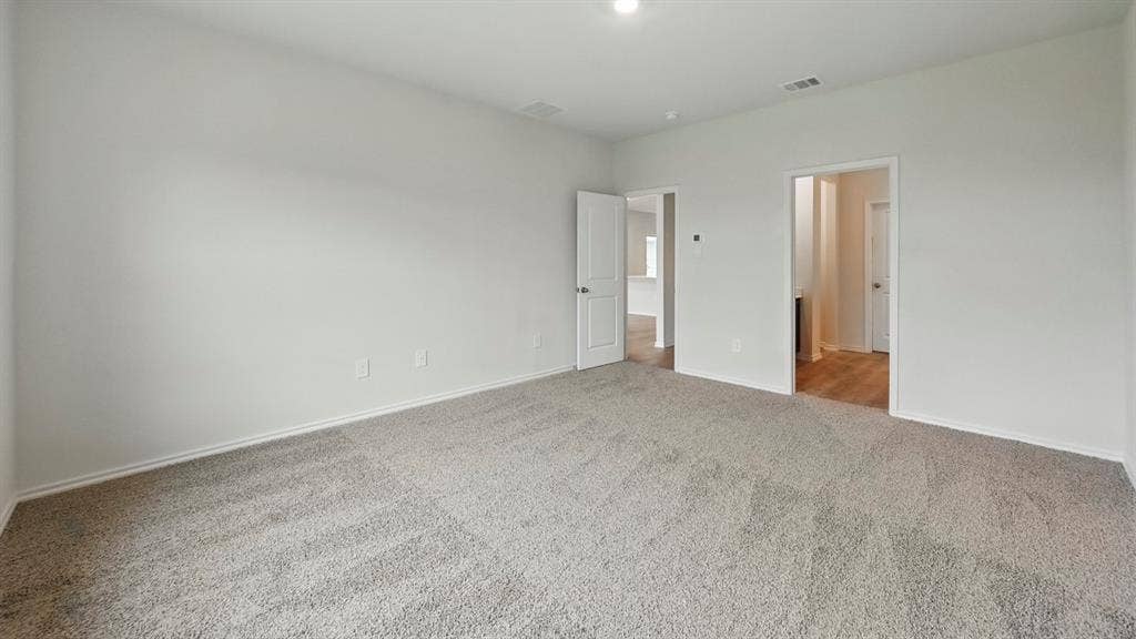 5602 Gannet Place, Crandall, TX 75114 Spacious room featuring neutral carpeting, white baseboards, light-toned wall paint, and recessed lighting