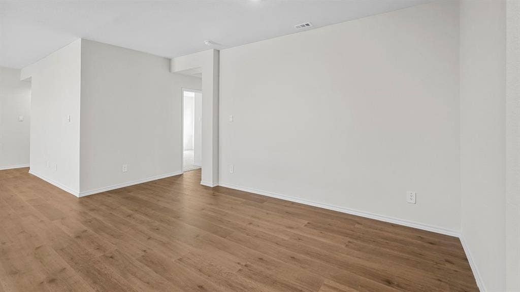 2912 Peppergrass Street, Royse City, TX 75189 Spacious room featuring wood-finish flooring, white baseboards, recessed lighting, and bright white walls