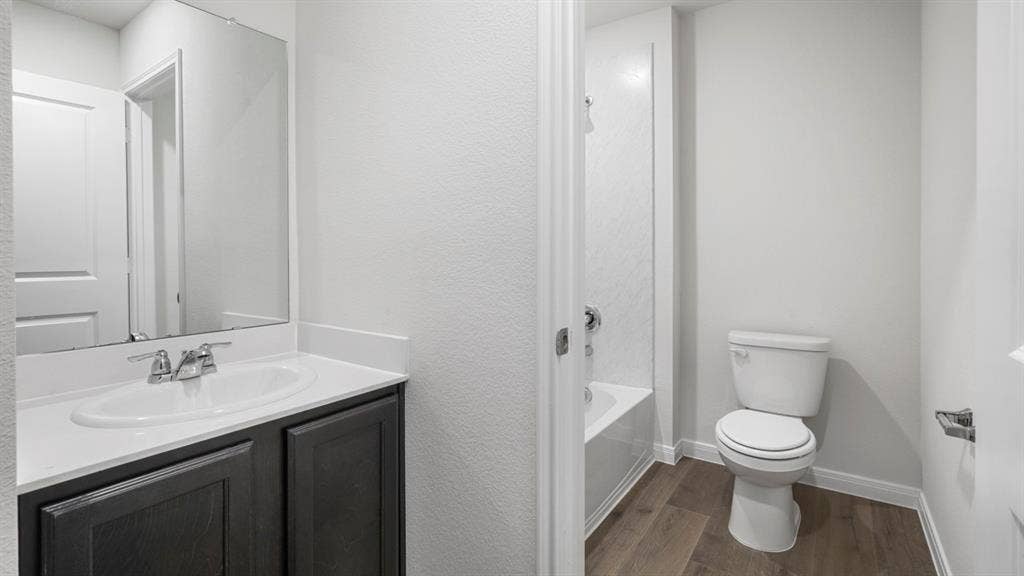 151 Arion Road, Waxahachie, TX 75165 Full bathroom featuring a dark wood-finish vanity with a white countertop, oval sink, and chrome faucet