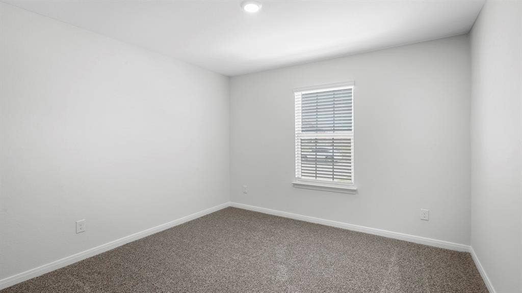 151 Arion Road, Waxahachie, TX 75165 Neutral wall color with baseboard trim, recessed ceiling lighting, textured carpet, and a window featuring horizontal blinds