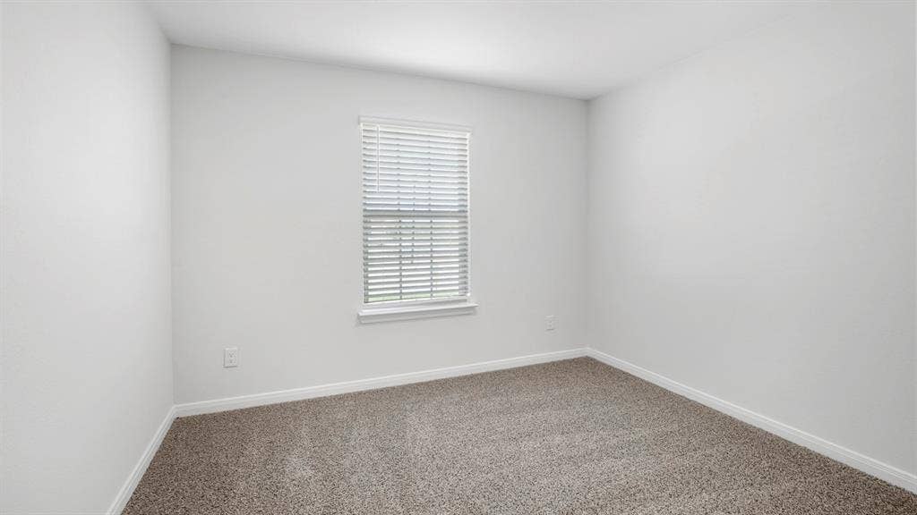 151 Arion Road, Waxahachie, TX 75165 Neutral-toned carpeted room featuring a single window with blinds, white trim, and light-colored walls