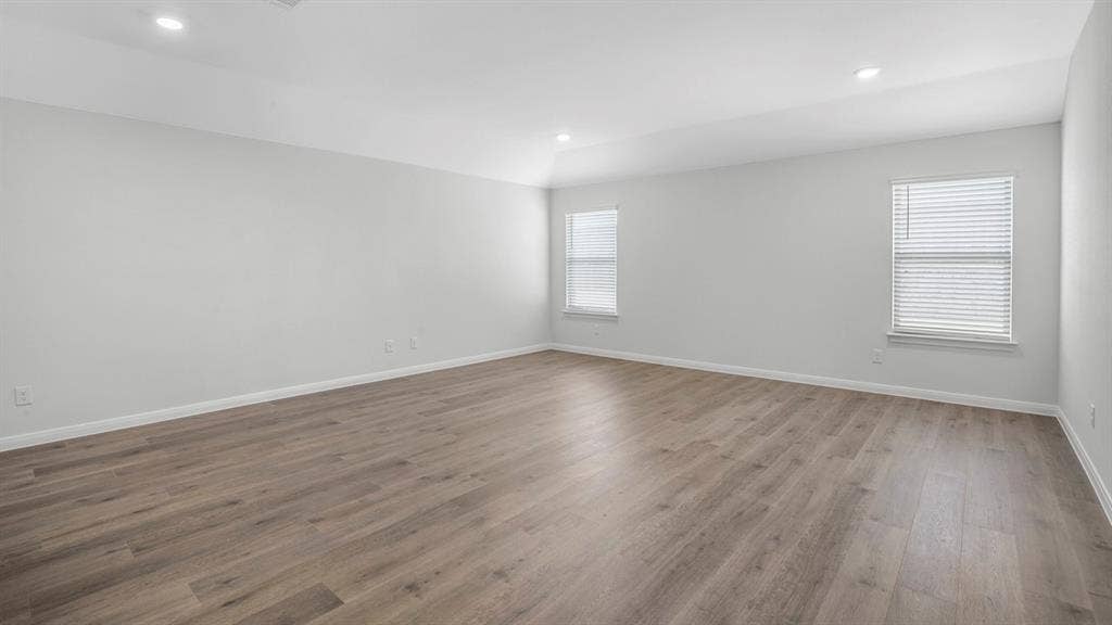 151 Arion Road, Waxahachie, TX 75165 Spacious interior room featuring wood-finish flooring, light gray wall paint, and white baseboards