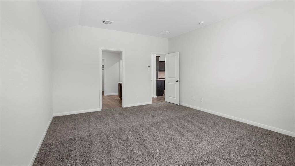 151 Arion Road, Waxahachie, TX 75165 Spacious room featuring neutral carpeting, light-toned walls, and white trim