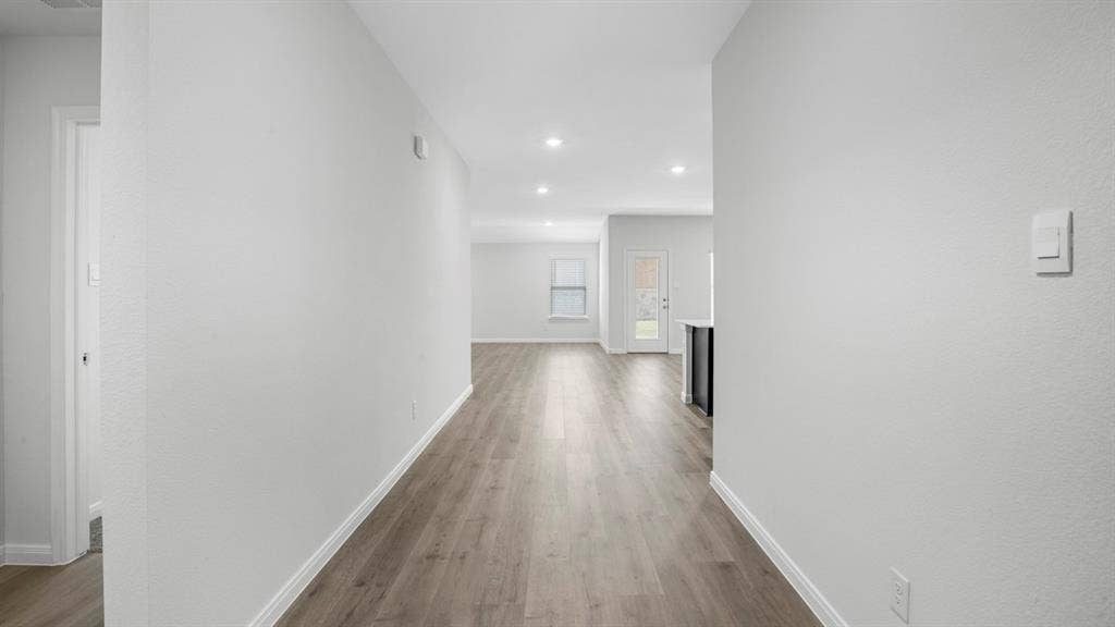 151 Arion Road, Waxahachie, TX 75165 Expansive hallway featuring wood-finish flooring, recessed lighting, and crisp white walls