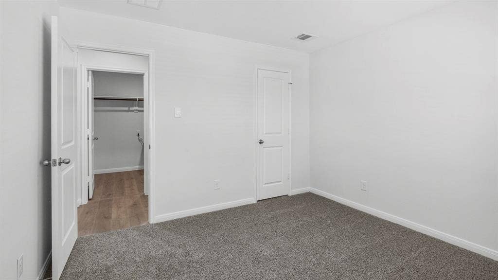 151 Arion Road, Waxahachie, TX 75165 Carpeted room with white walls and trim