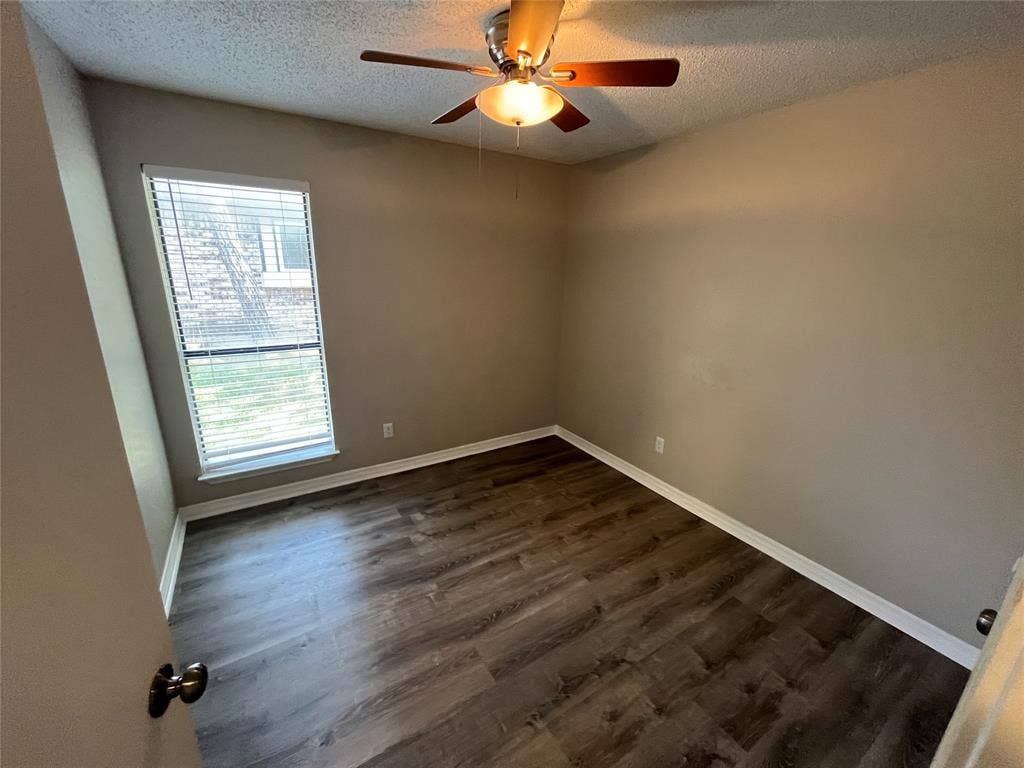 2405 Brookside Drive, Rowlett, TX 75088 Wood-finish flooring, ceiling fan with integrated lighting, neutral wall tones, and window with blinds