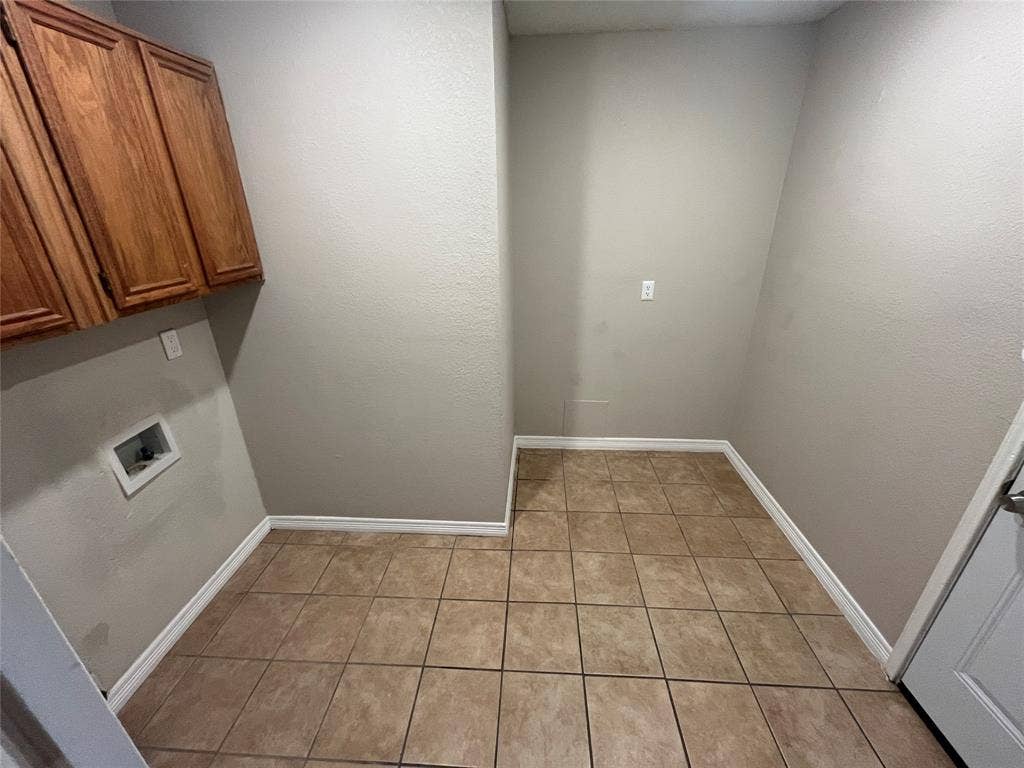 2405 Brookside Drive, Rowlett, TX 75088 Wood-finish upper cabinetry provides storage