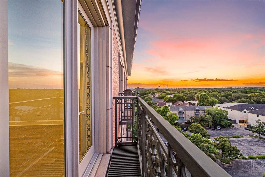 4240 Prescott Avenue, #8B, Dallas, TX 75219 Balcony with ornate metal railing and expansive treetop scenery