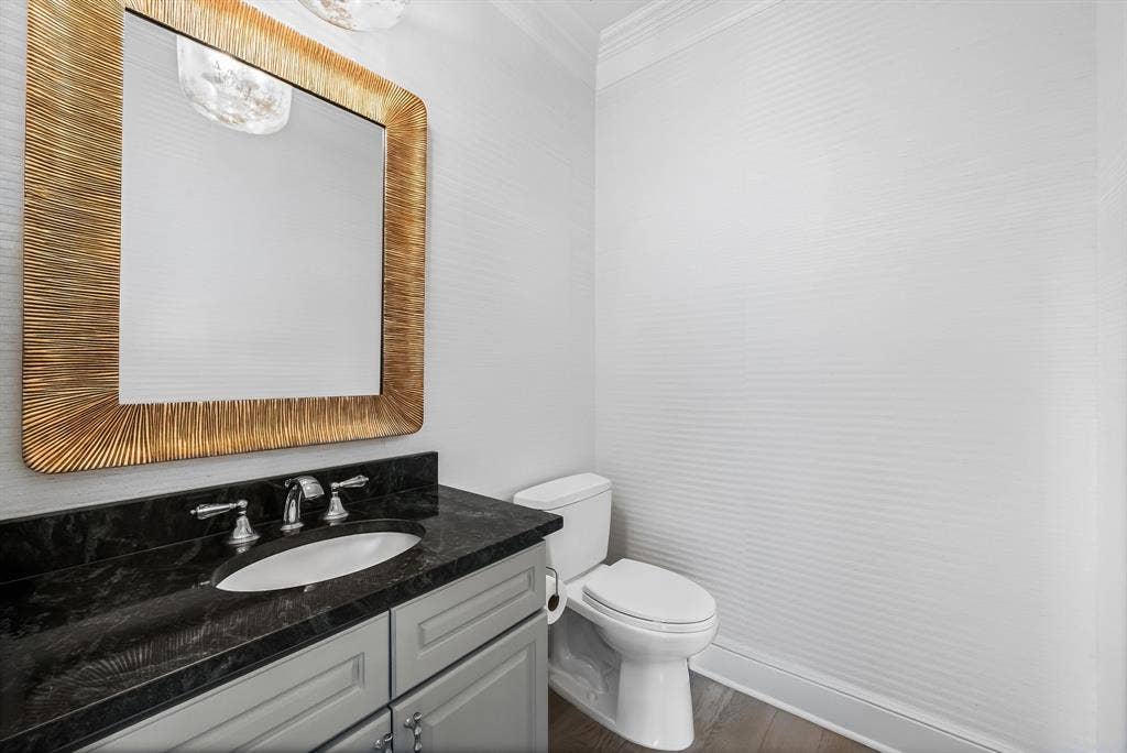 4240 Prescott Avenue, #8B, Dallas, TX 75219 Vanity featuring a dark stone countertop with an undermount sink and chrome fixtures