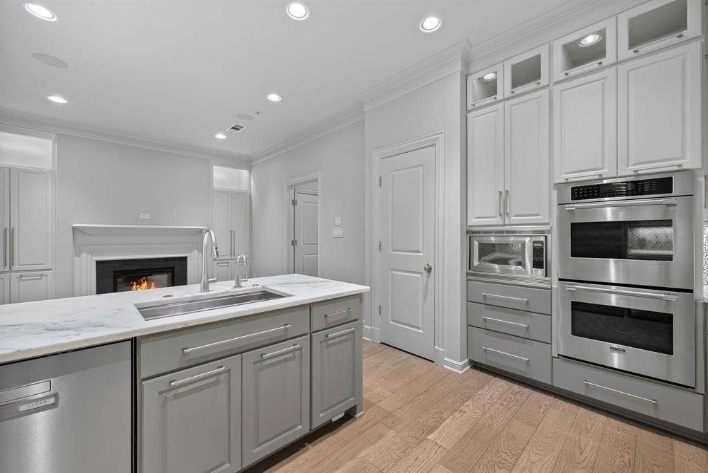 4240 Prescott Avenue, #8B, Dallas, TX 75219 Expansive kitchen island featuring a stainless steel undermount sink and a dishwasher