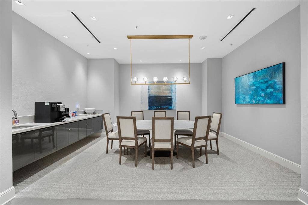 4240 Prescott Avenue, #8B, Dallas, TX 75219 Dedicated meeting room featuring recessed lighting, a linear brass chandelier, and a built-in refreshment bar with a sink and ample counter space