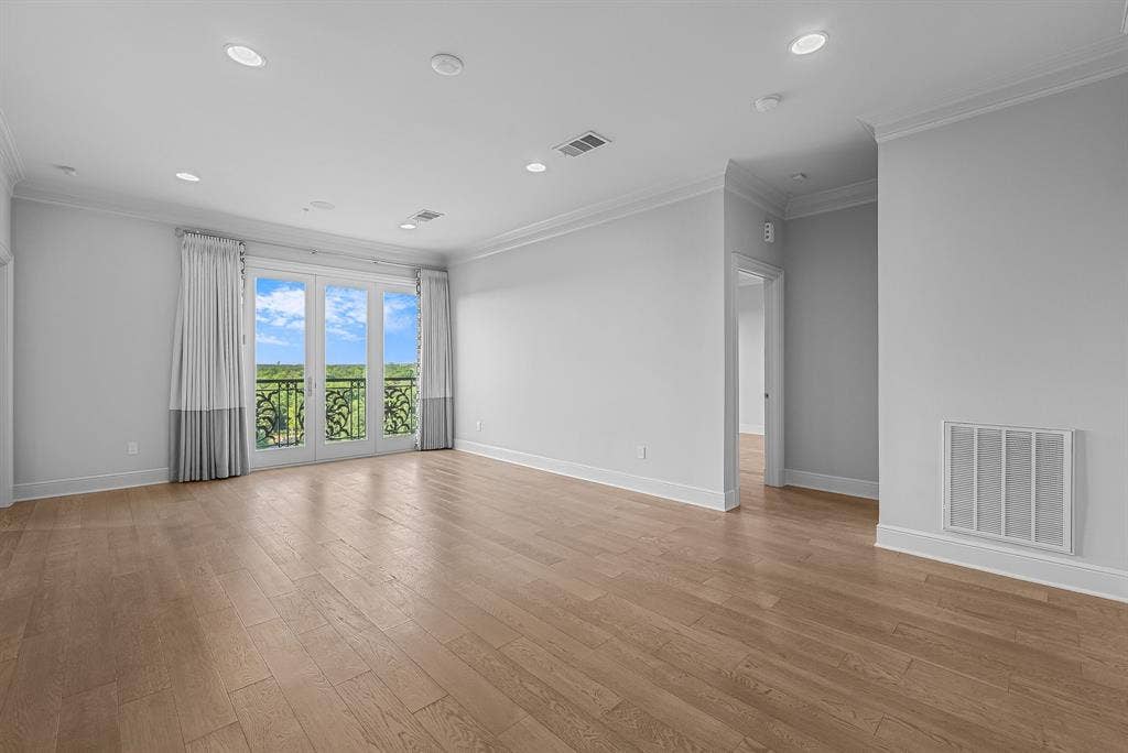 4240 Prescott Avenue, #8B, Dallas, TX 75219 Spacious room featuring light wood-finish flooring, recessed lighting, and crown molding