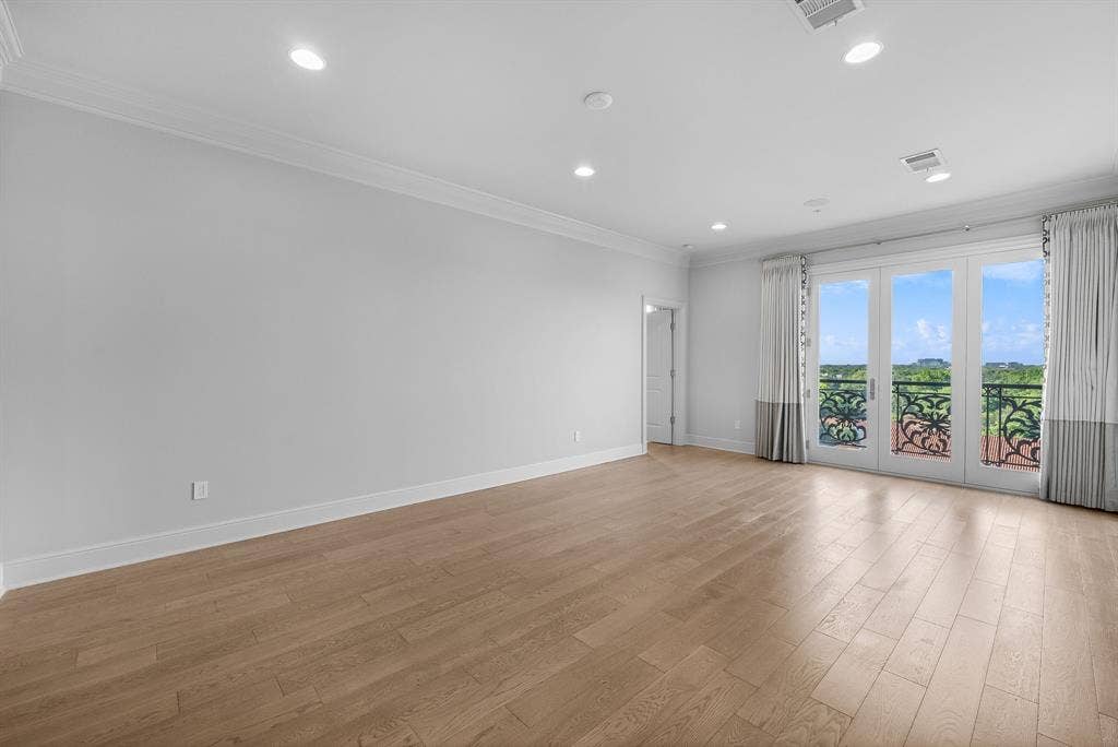 4240 Prescott Avenue, #8B, Dallas, TX 75219 Spacious room featuring wood-finish flooring, recessed lighting, and crown molding