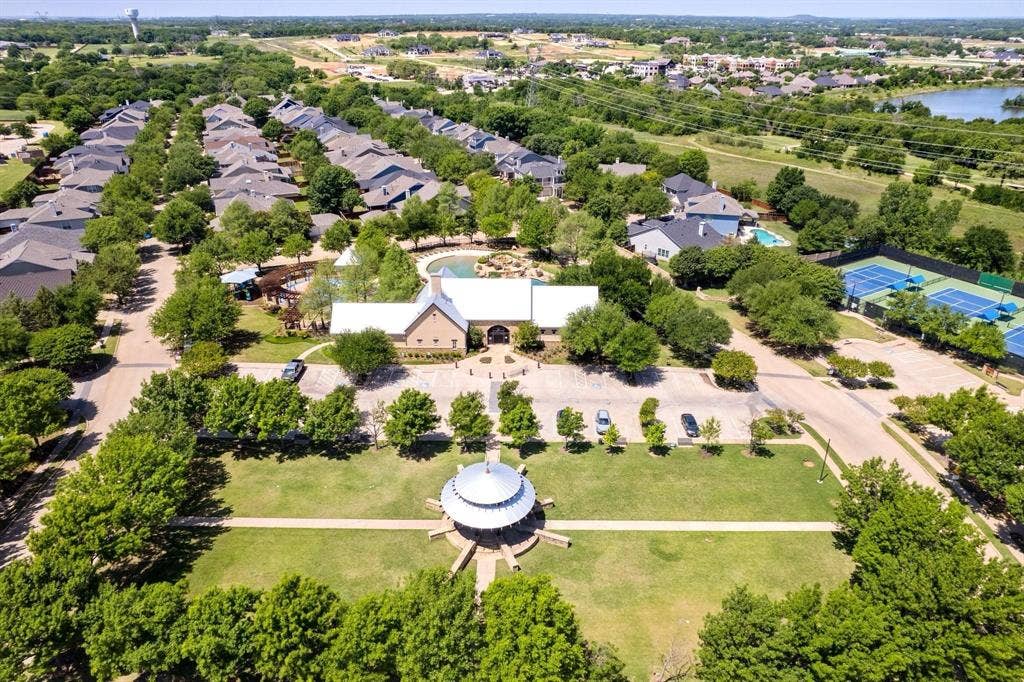 Aerial view highlighting the community clubhouse, swimming pool, and tennis courts