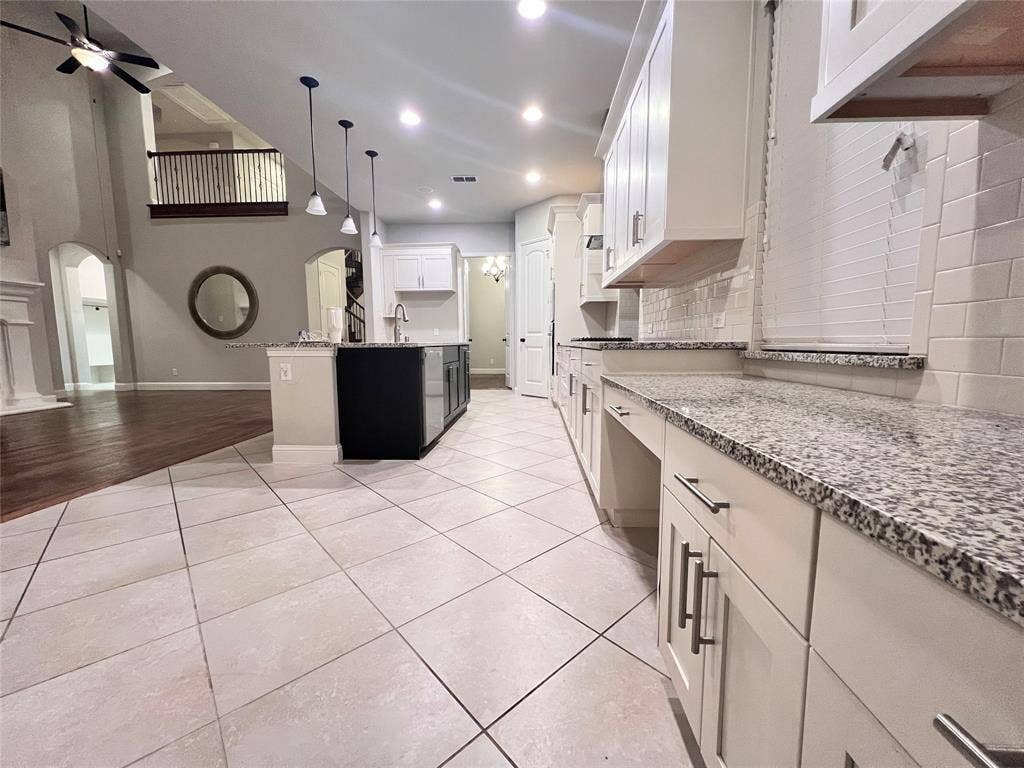 Kitchen featuring light tile flooring and granite countertops