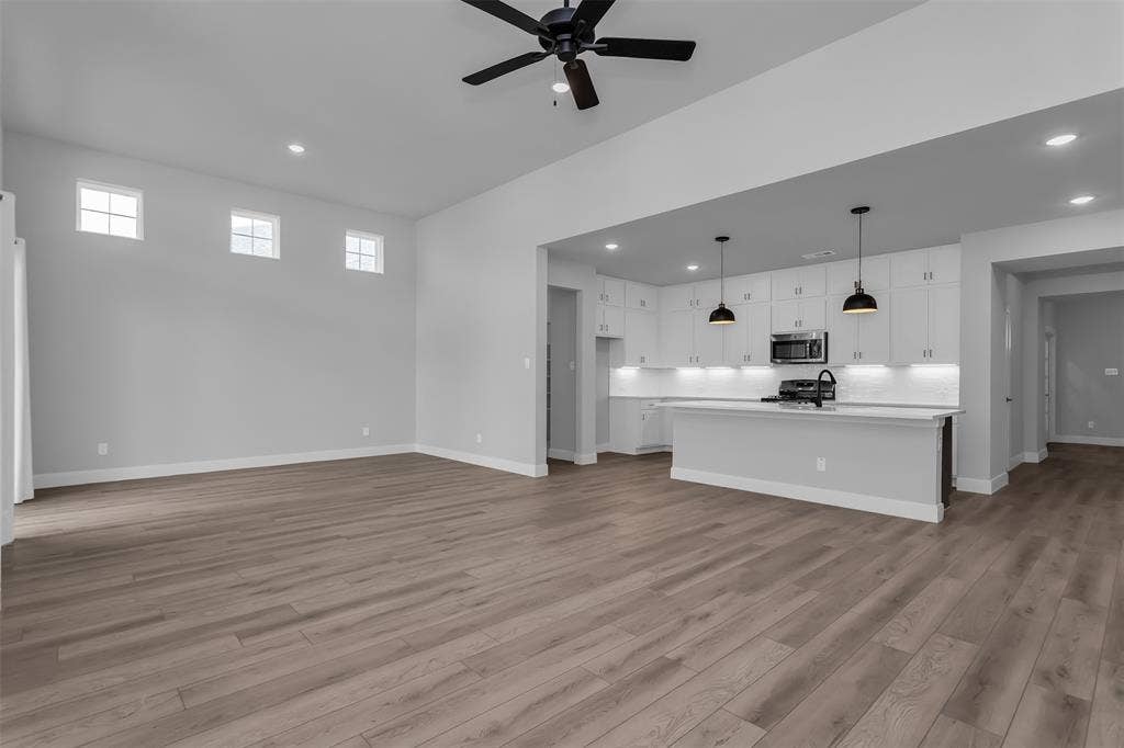 1031 Rylan Street, Midlothian, TX 76065 Open-concept living space featuring wood-finish flooring, recessed lighting, and a ceiling fan