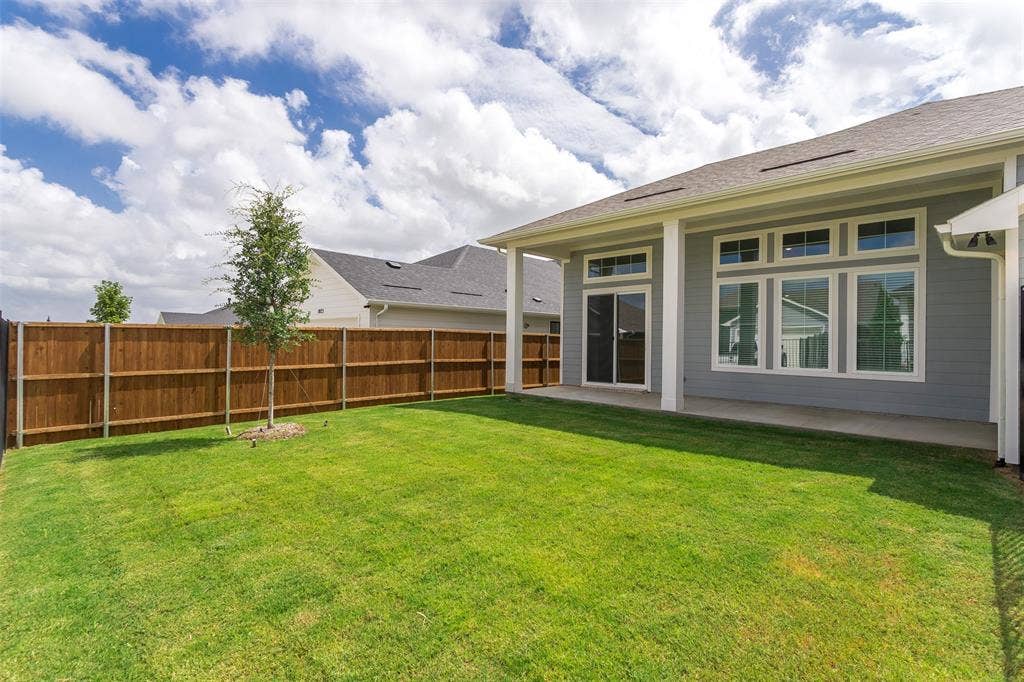 1031 Rylan Street, Midlothian, TX 76065 Expansive green lawn with a newly installed privacy fence