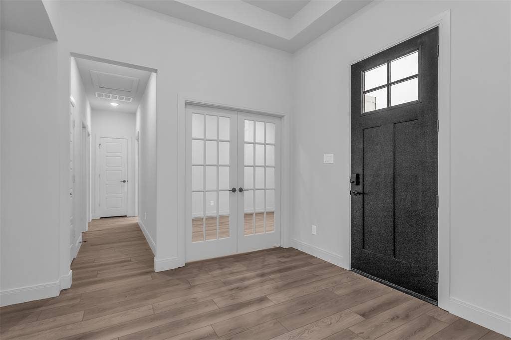 1031 Rylan Street, Midlothian, TX 76065 Entryway featuring a dark paneled front door with a transom window, French doors, wood-finish flooring, white baseboards, and a recessed ceiling
