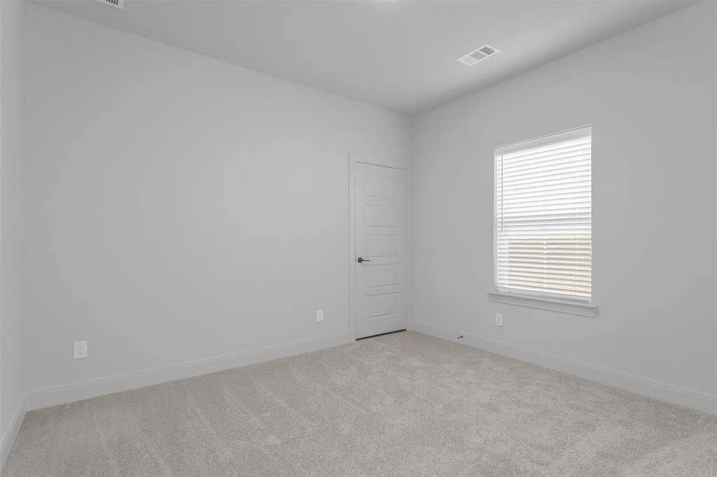 1031 Rylan Street, Midlothian, TX 76065 Neutral-toned room featuring a single window with blinds, light gray wall paint, and gray carpeting