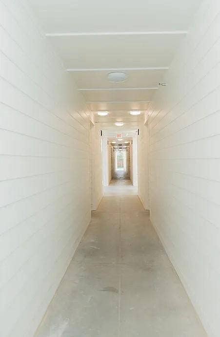 1514 E 15th Street, #10, Plano, TX 75074 Elongated hallway with light-toned walls and a concrete floor