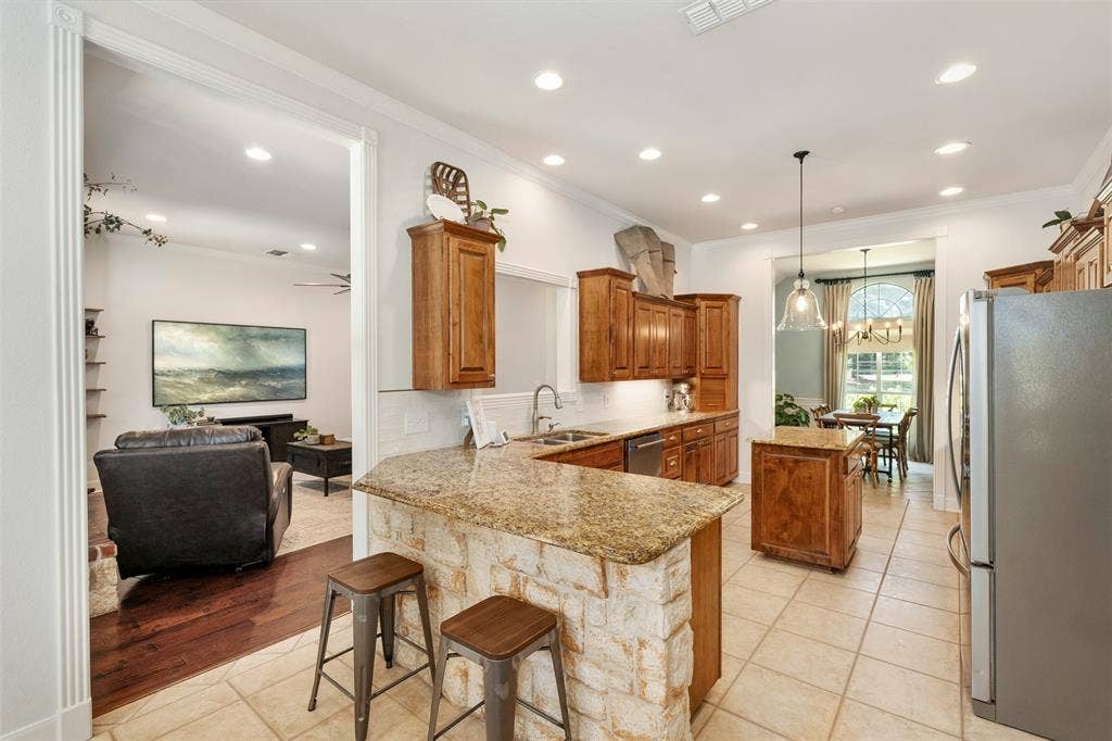 large kitchen connected to breakfast area and formal dining room