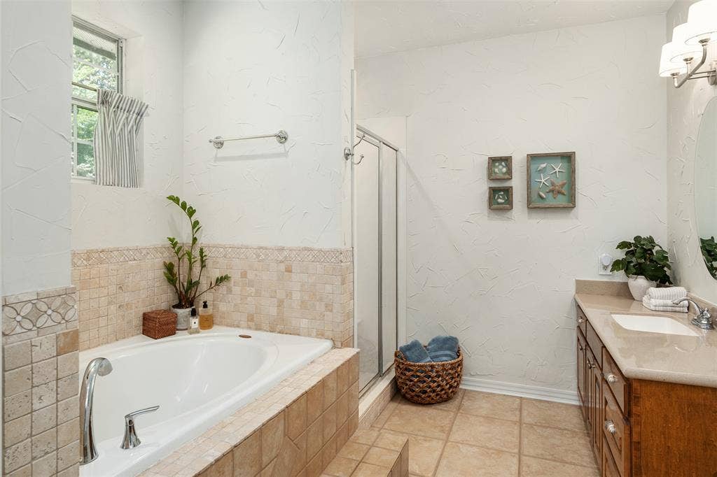 primary bathroom with separate tub and shower