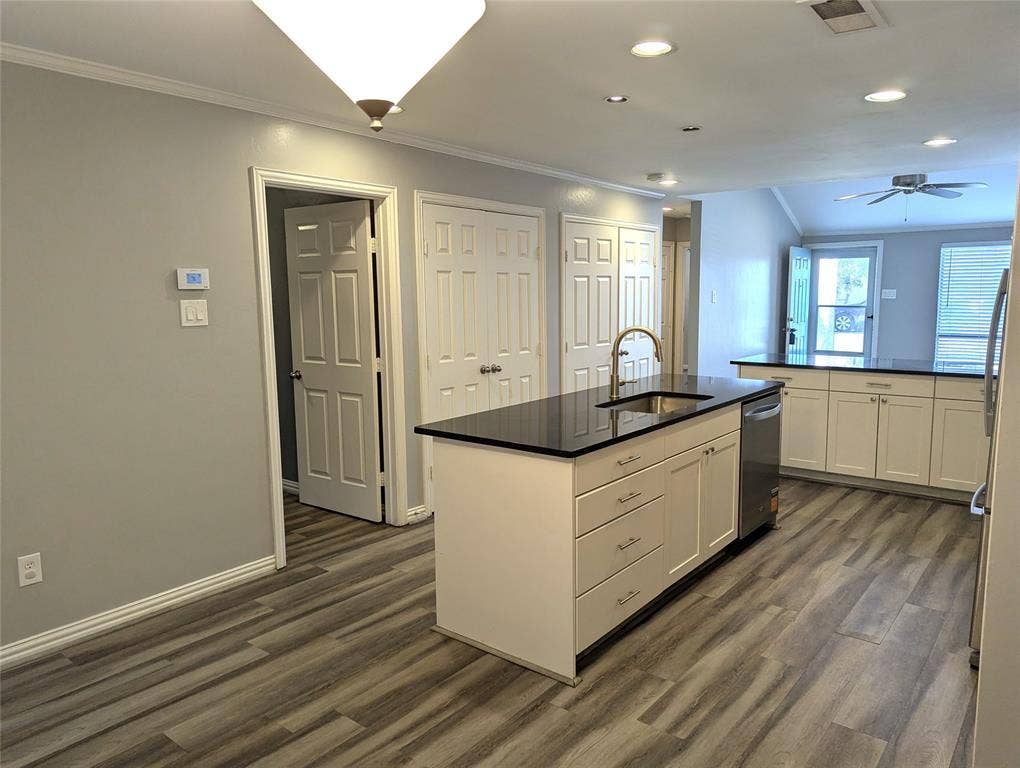 509 Pine Trail Drive, Allen, TX 75002 Open-concept kitchen featuring an island with a stainless steel sink and a gooseneck faucet