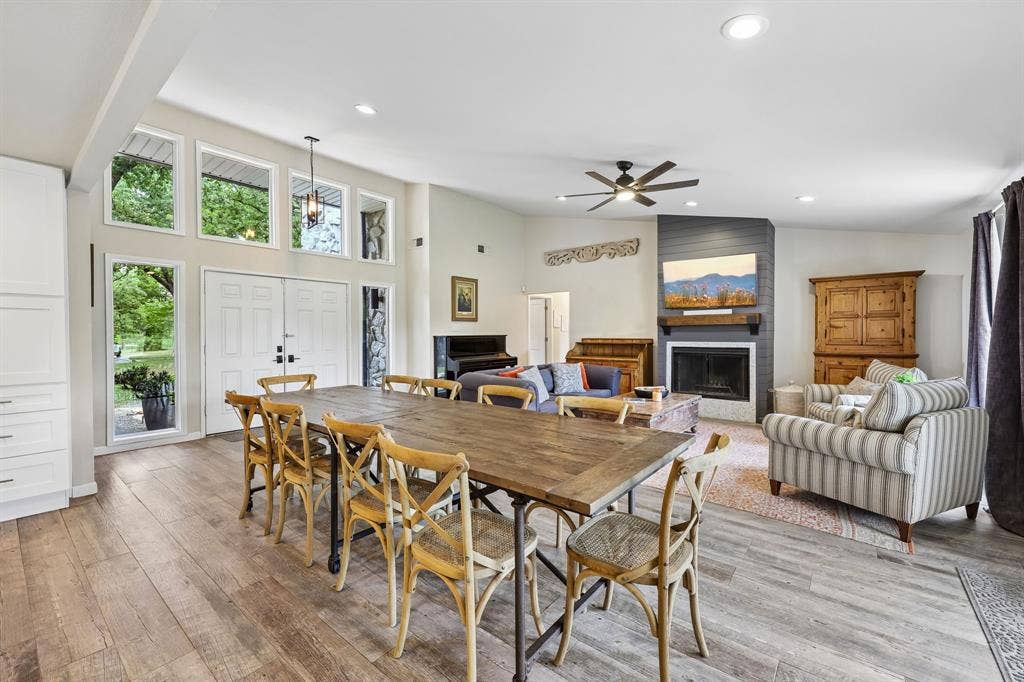 711 Bandit Trail, Keller, TX 76248 Soaring vaulted ceiling with recessed lighting, wood-finish flooring, white built-in cabinetry, and a fireplace with a mantel