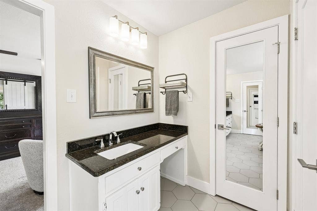 711 Bandit Trail, Keller, TX 76248 White vanity with storage, dark countertop, rectangular undermount sink, and polished chrome faucet