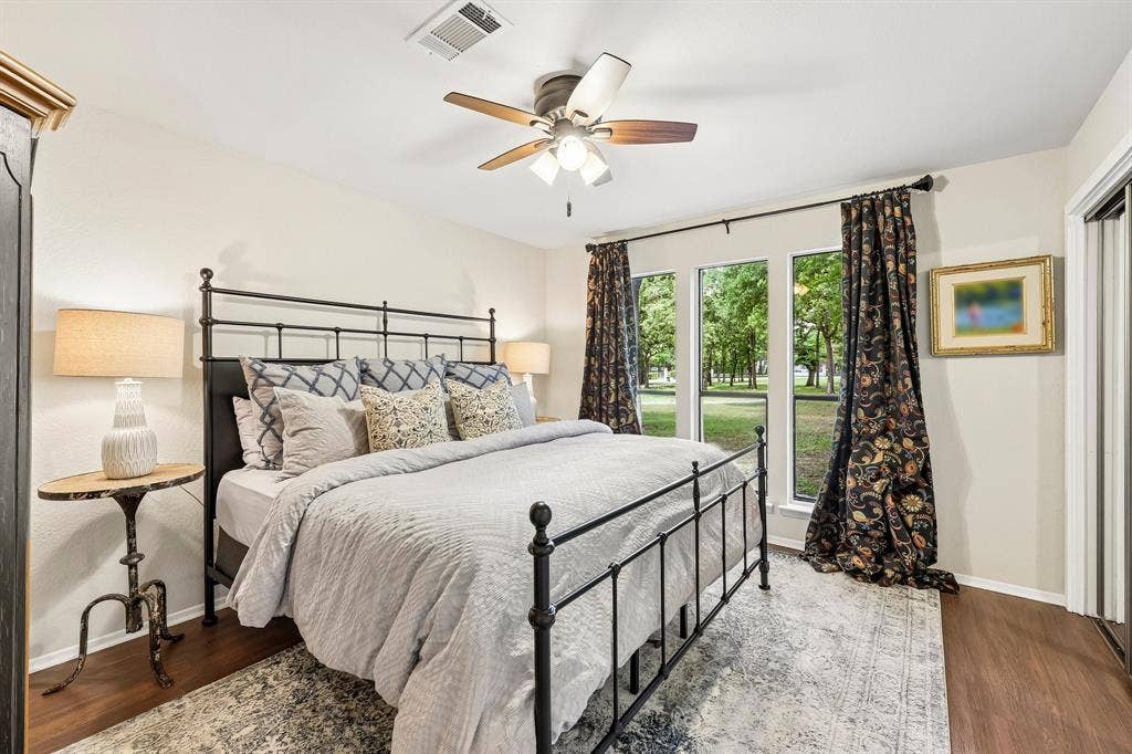 711 Bandit Trail, Keller, TX 76248 Wood-finish flooring, ceiling fan with integrated lighting, multiple windows, and a built-in closet with sliding doors