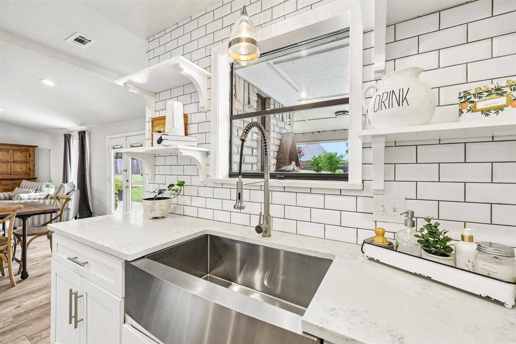 711 Bandit Trail, Keller, TX 76248 Farmhouse sink with a gooseneck faucet, subway tile backsplash, white shaker cabinetry, light-toned countertop, and recessed lighting