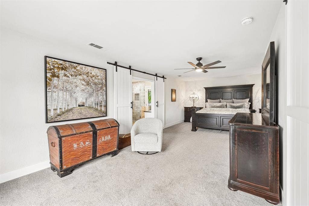 711 Bandit Trail, Keller, TX 76248 Plush carpeting, ceiling fan with light fixture, and white barn doors on a black track