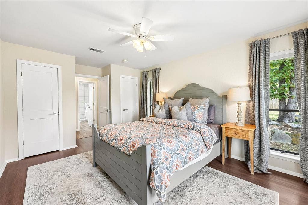711 Bandit Trail, Keller, TX 76248 Expansive bedroom featuring wood-finish flooring, a ceiling fan, and a large window with exterior landscaping visible
