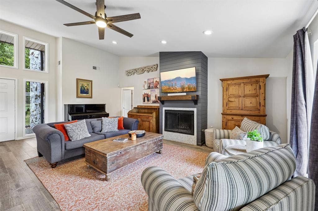 711 Bandit Trail, Keller, TX 76248 Vaulted ceiling, wood-finish flooring, corner fireplace with a floating mantel, recessed lighting, and a ceiling fan with integrated lighting