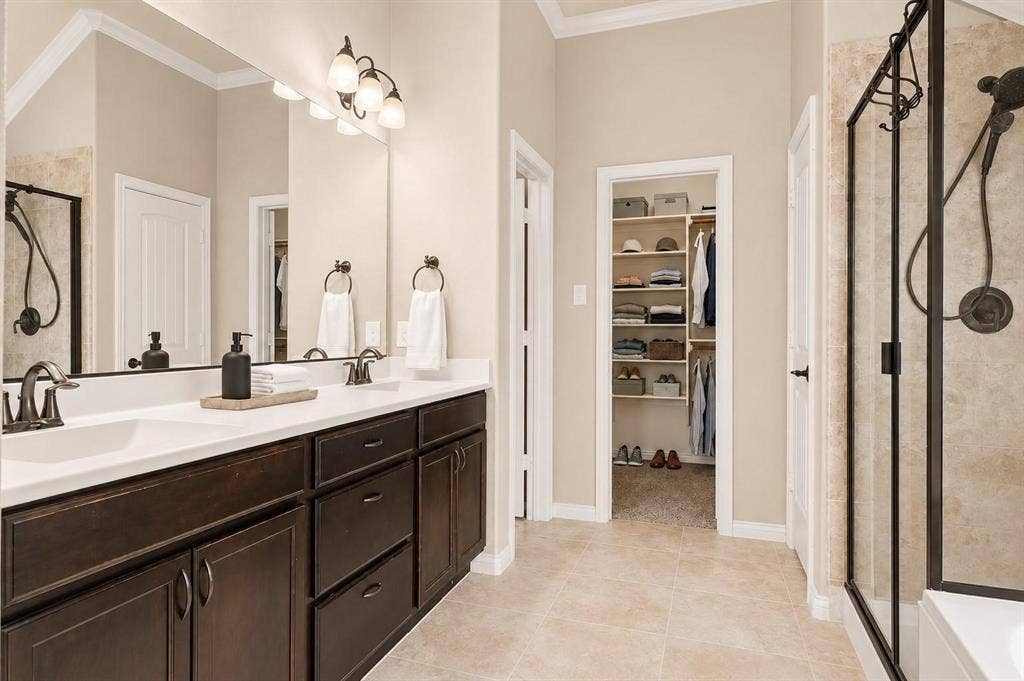 Double vanity with dark wood-finish cabinetry and white countertops
