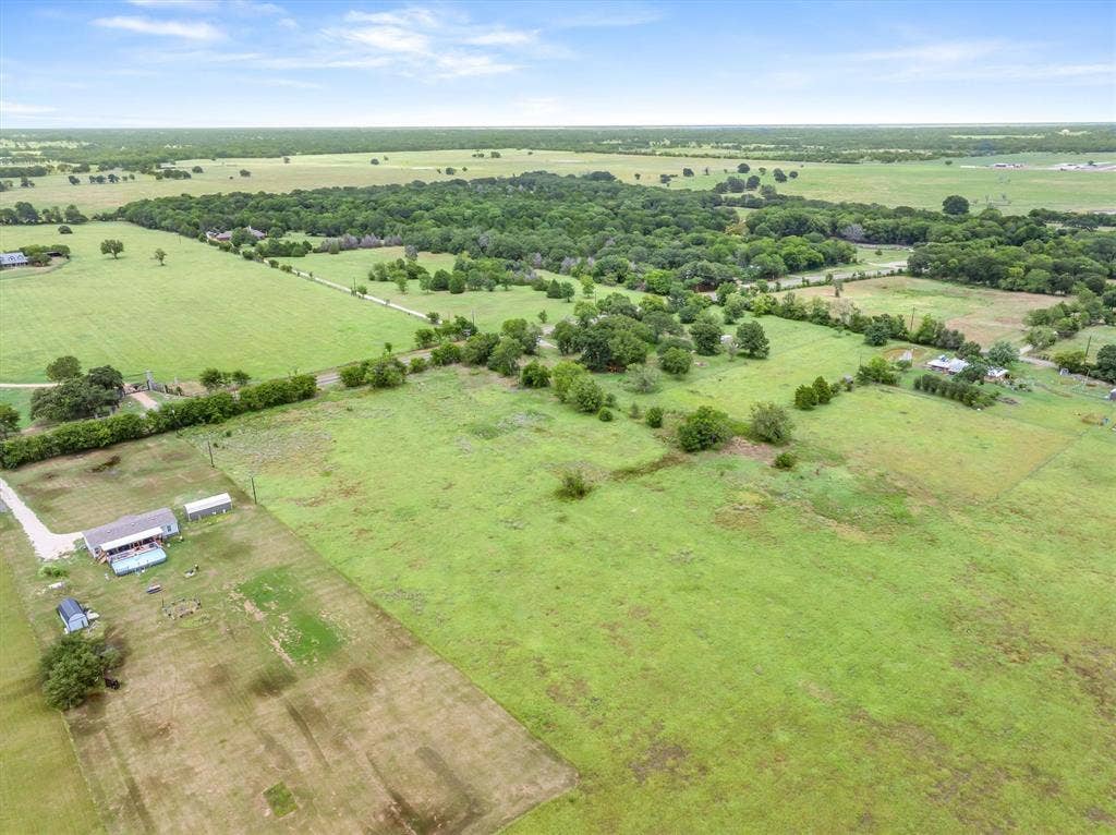 Lot 3R W. Cedar PKWY, Kemp, TX 75143 Expansive green landscape featuring scattered trees and a distant wooded area under a clear sky