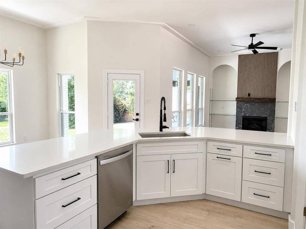 1706 Fairhaven Drive, Mansfield, TX 76063 Modern kitchen featuring white cabinetry, light countertops, and a stainless steel dishwasher