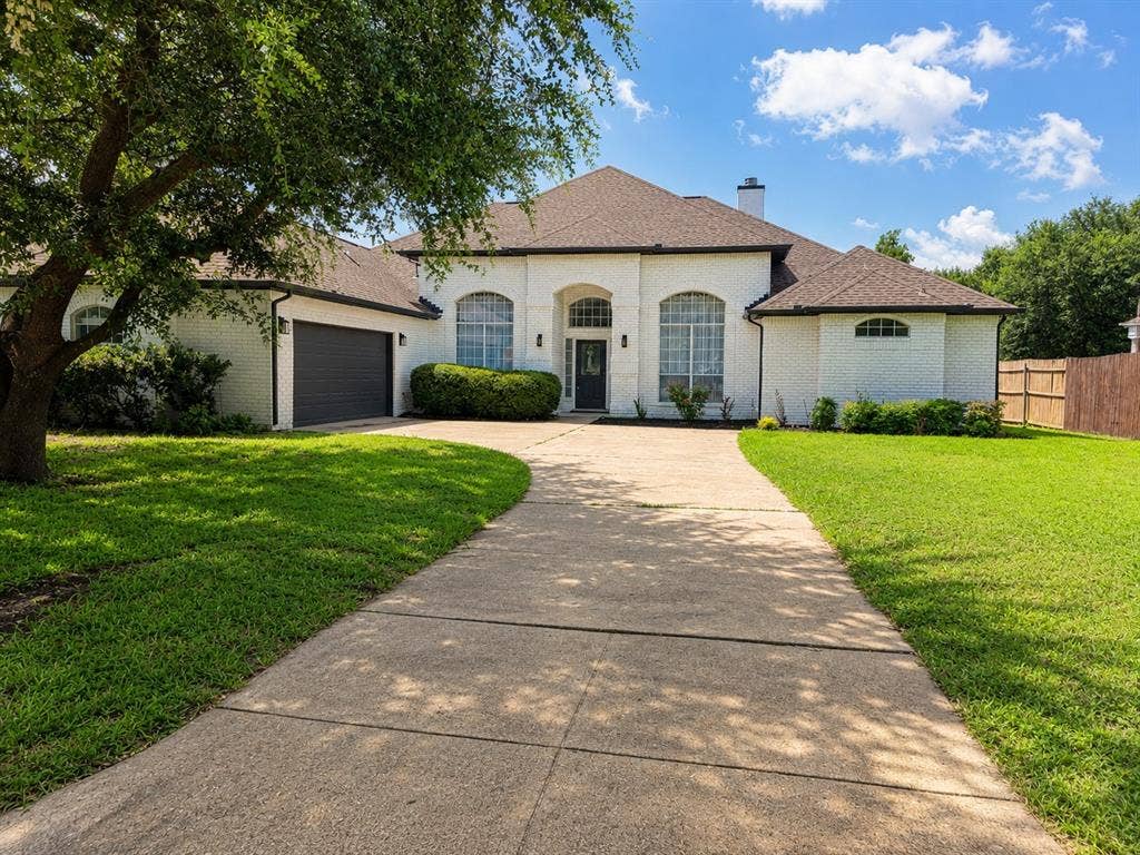 1706 Fairhaven Drive, Mansfield, TX 76063 White brick exterior with dark trim and a brown shingle roof