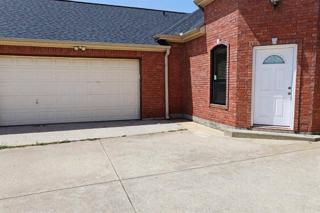 Front door and attached garage on left hand side