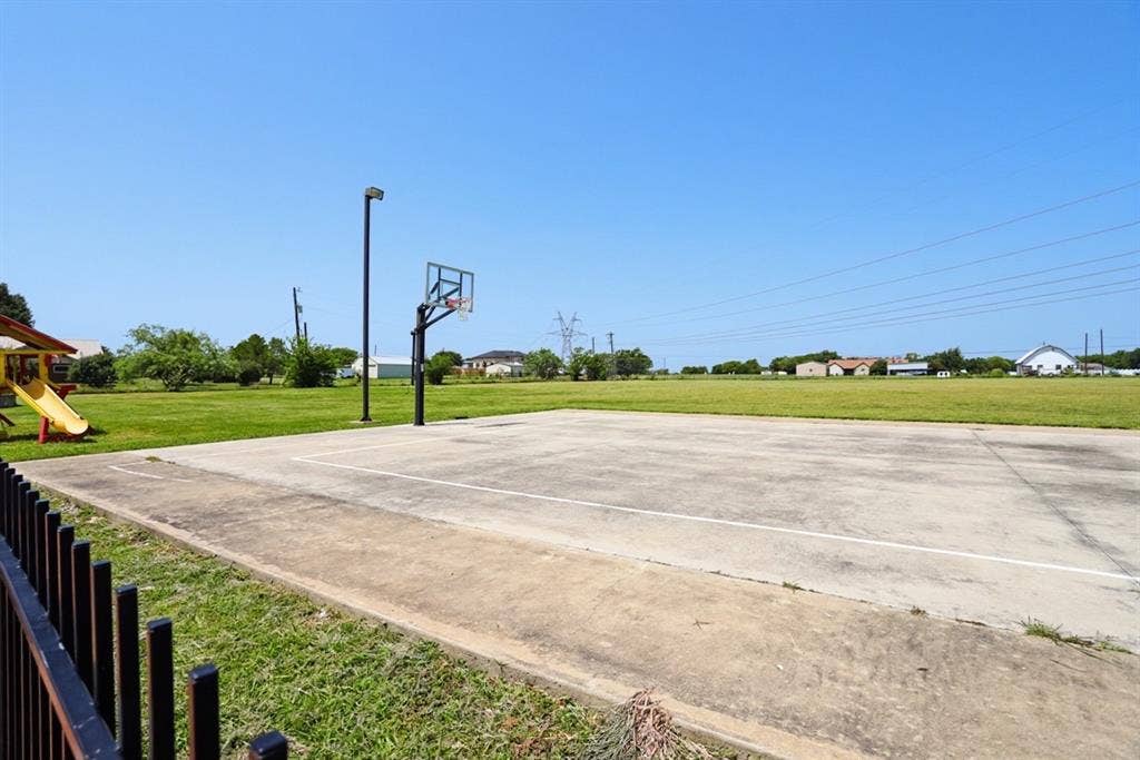 Full size basketball court and large backyard