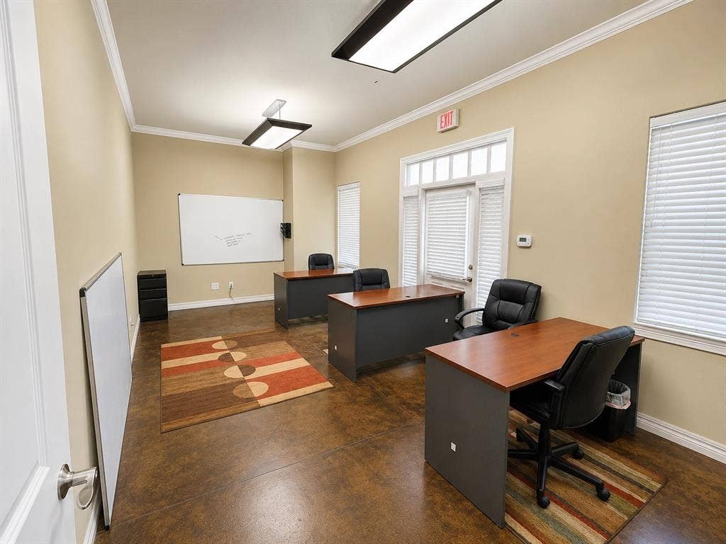 305 W Spring Creek Parkway, #5A, Plano, TX 75023 Spacious room featuring durable concrete flooring, crown molding, and neutral wall tones