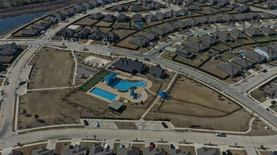 Aerial perspective showcasing a residential community with a large central amenity area