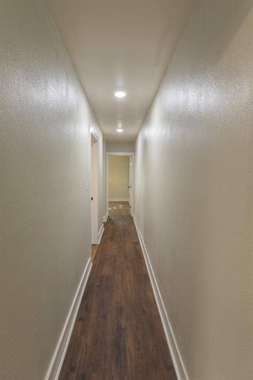 613 N 23rd Street, #15, Waco, TX 76707 Hallway featuring recessed lighting, wood-finish flooring, light neutral wall color, white trim, and a white interior door