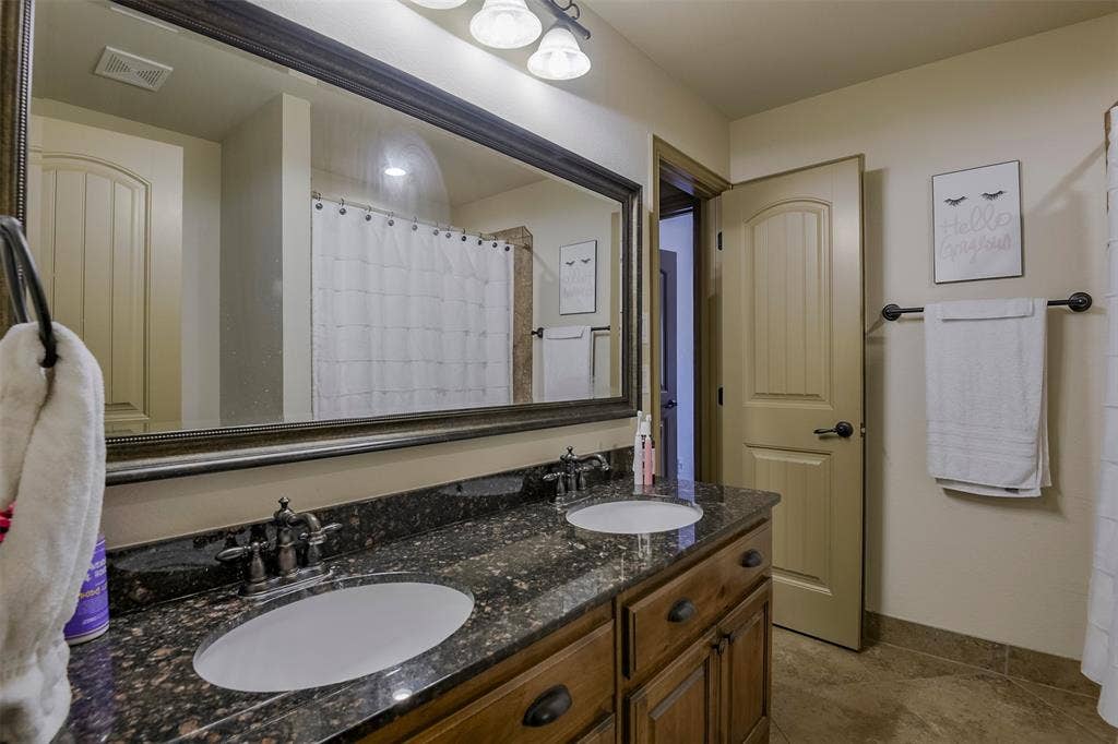 Dual vanity with under-mount sinks and dark speckled countertop