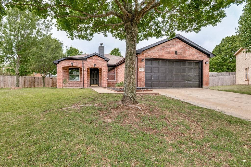 Brick exterior with dark trim and a single-car garage