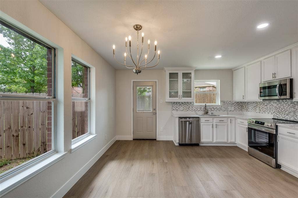 Open-concept kitchen and dining area featuring light wood-finish flooring