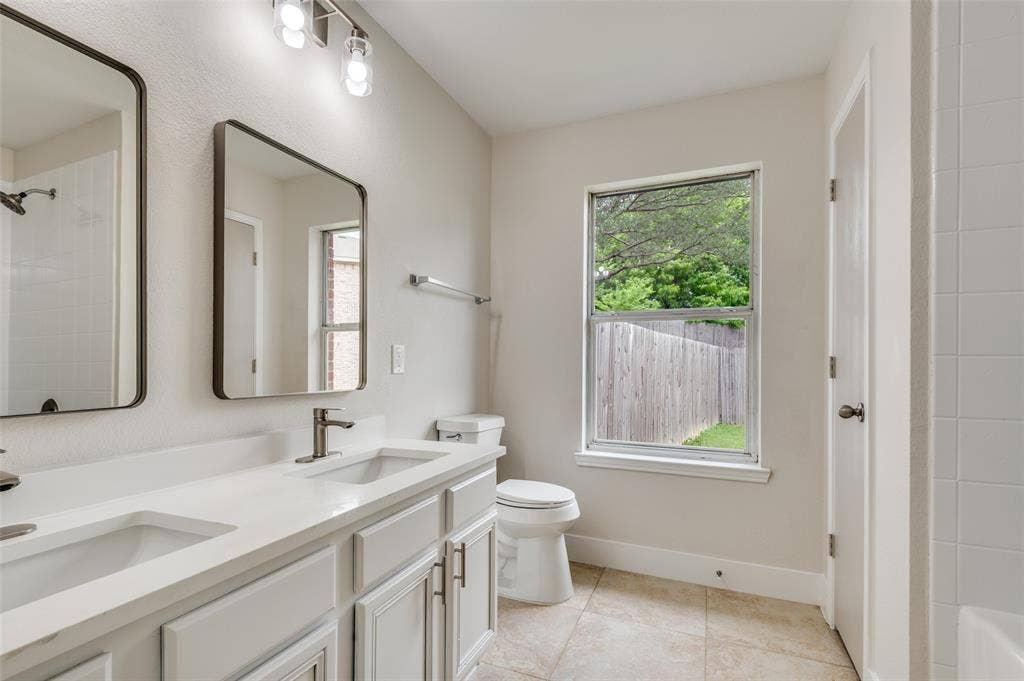 Dual vanity featuring white shaker-style cabinetry, undermount sinks, and contemporary wall-mounted mirrors