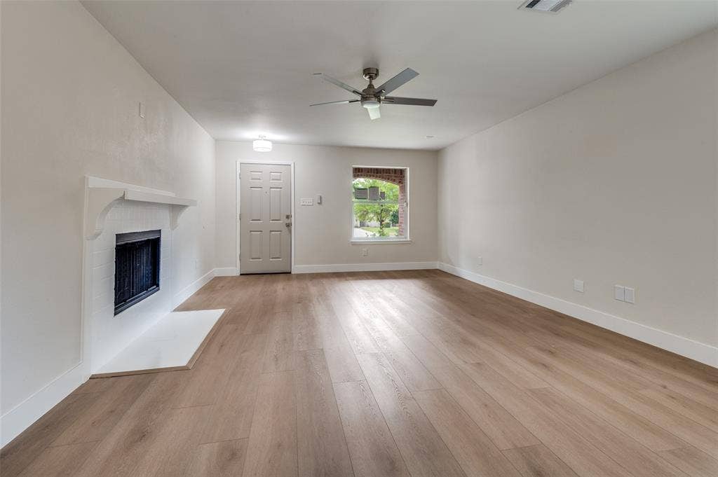 Bright living area featuring wood-finish flooring, a white mantelpiece, recessed lighting, and a ceiling fan