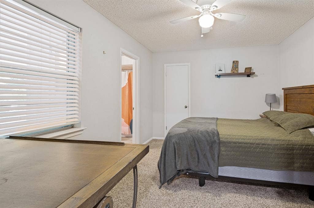 404 Green River Trail, Fort Worth, TX 76103 Bedroom featuring light-toned carpeting and white painted walls